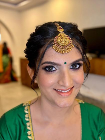 Good makeup equals a good mood. This bride's smile sparkles through her eyes, which are defined with a classic kohl-rimmed look perfect for her traditional attire.