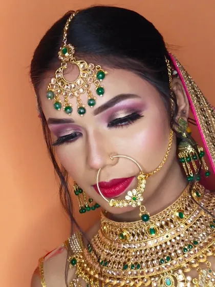 The full bridal eye makeup with eyes closed, showing the smooth blend of pink and gold glitter.