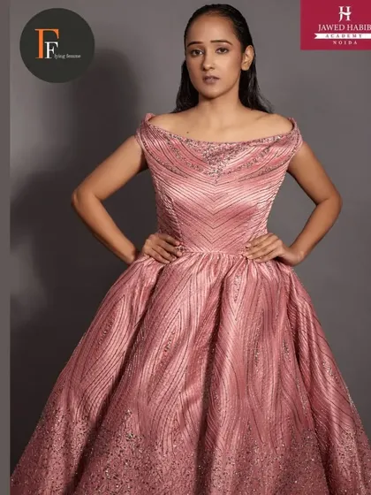 Another shot of the model in the pink gown, highlighting the wet hair look and glowing skin.