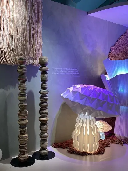 Another view of the glowing mushroom lamps from the 'Shroom' installation. The intricate paper folding and internal lighting create a variety of beautiful and complex forms.