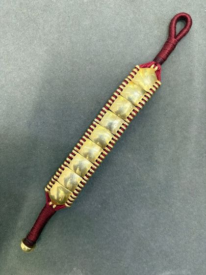 One of our prettiest everyday wear silver bracelets. This design features gold-plated silver squares woven onto a red thread.