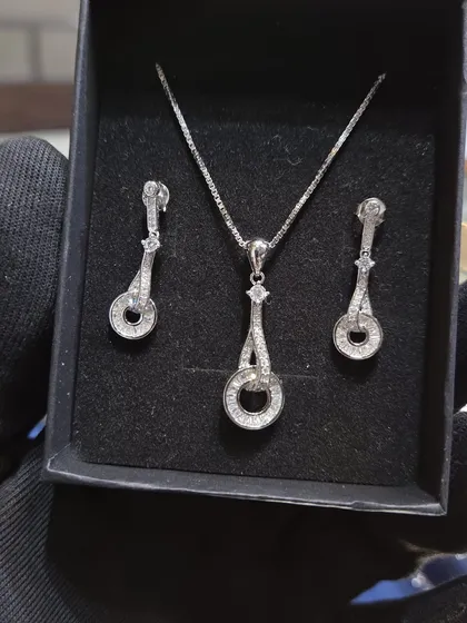 Another beautiful silver pendant set. This one features a classic design with sparkling stones, perfect for any occasion.