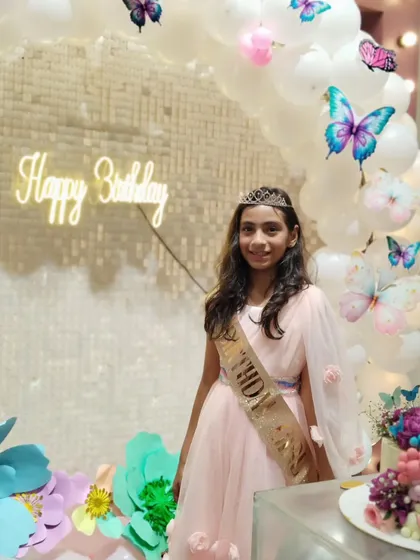 The birthday girl, Avisha, looking radiant in front of her butterfly-themed backdrop. We love helping create these picture-perfect moments.