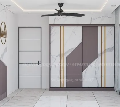 A luxurious sliding wardrobe with a marble and grey finish, accented with gold strips. This design coordinates with the room's overall theme, creating a cohesive and high-end look.