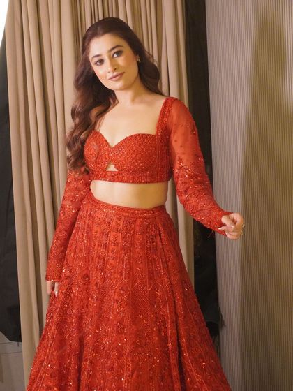 A beautiful shot of our new red lehenga, perfect for any bride or bridesmaid looking to make a statement. It's available for both rent and customization.