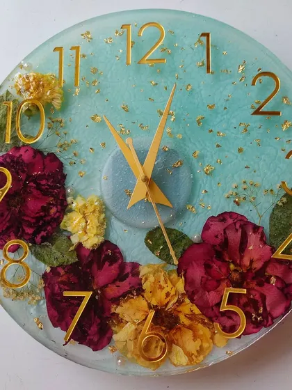 This floral preservation clock was a true labor of love, taking a week to complete. I embedded a client's treasured flowers against a soft blue background with gold accents, creating a functional piece of art that is completely unique to them.