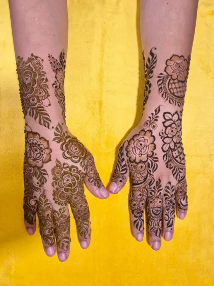 Another view of the Dubai-style floral mehndi, showing the beautiful, flowing patterns on both hands.