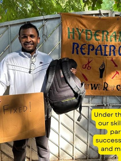Fixed! A participant proudly holds up his repaired backpack. Learning to fix your own bag is an empowering and practical skill.
