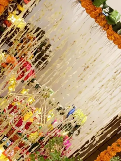 A top-down view of the mandap decoration, showing the neat arrangement of marigold and tuberose flower strings that form a beautiful canopy for the pooja.