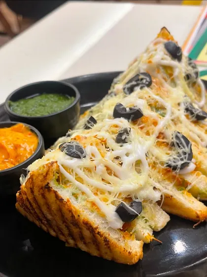 A closer look at my cheesy grilled sandwich, served with our signature green chutney and a tangy dip. It's a perfect snack or a light meal.