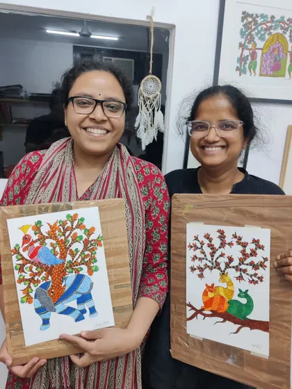 Two participants from our Gond art workshop proudly show their intricate creations. We love exploring traditional Indian art forms and making them accessible to everyone, regardless of prior experience.