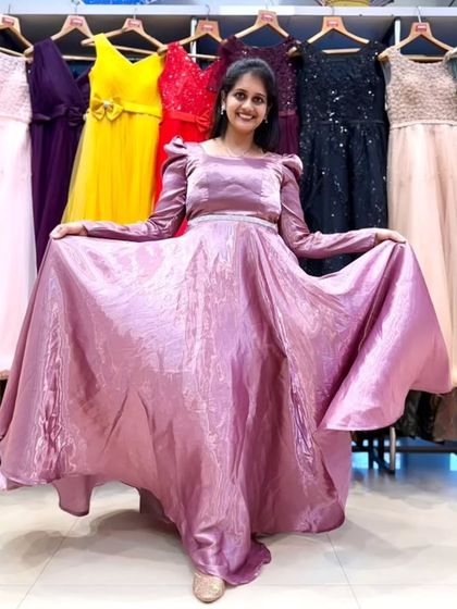A lovely mauve A-line gown with puff sleeves and a shimmering fabric. It’s a modest yet fashionable choice for a family function or formal dinner.