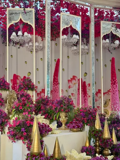 A close-up of the mirrored panels with a traditional arch design, reflecting the chandeliers and the vibrant floral arrangements.
