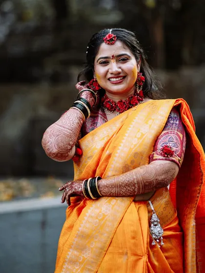 A beautiful portrait of the bride at her Haldi ceremony, dressed in a yellow saree with floral jewellery.