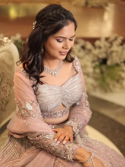 A beautiful portrait of the bride, seated gracefully. The soft lighting and elegant decor create a perfect setting for her romantic engagement look.
