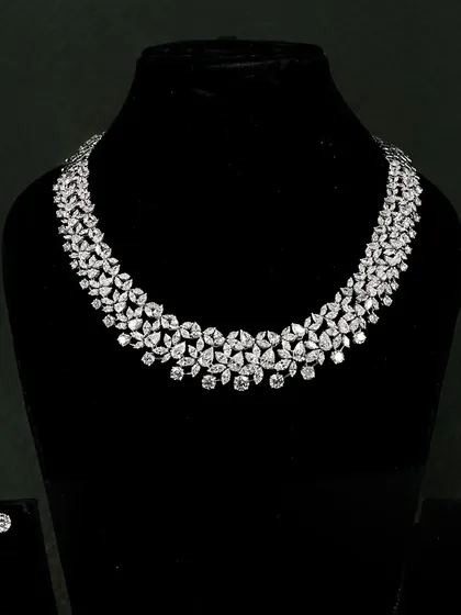 This classic diamond necklace is designed for unforgettable moments. It features floral clusters of round and pear-shaped diamonds that drape beautifully around the neck.