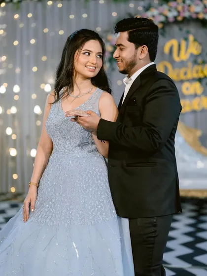 A romantic dance between the engaged couple. The bride's soft glam makeup looks beautiful under the sparkling lights.