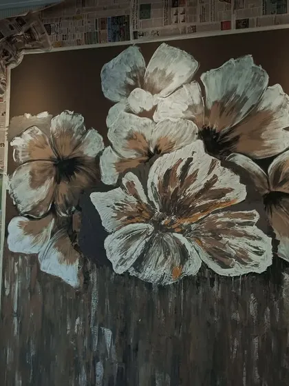 Here, you can see the floral design taking shape. The background texture is complete, and I am building up the layers of the white and gold petals on top.