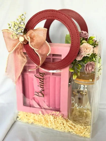 Personalization is key. This stylish bag hamper was created for Brinda, featuring a custom name tag on the bag and a personalized sipper, making it a unique and practical gift for a bridesmaid or friend.