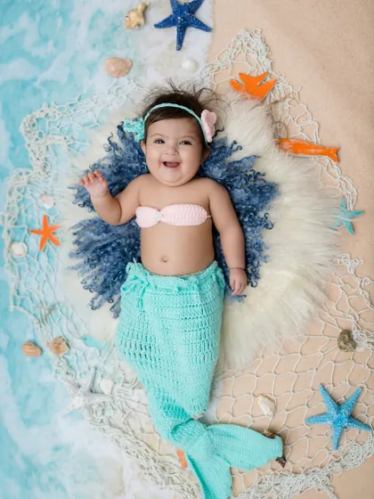 Waving hello from her little ocean scene. This is such a magical theme for a baby photoshoot.