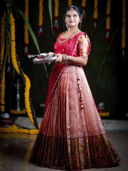 For the Makara Sankranthi festival, I designed this exquisite Zari Kota lehenga for my client. The peach skirt with a traditional border is paired with a red brocade blouse, creating a vision of grace and tradition.