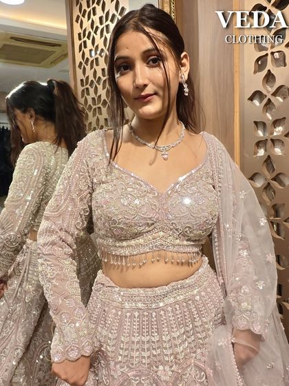 Another close-up of the pastel pink lehenga's blouse. The detailed beadwork and sequins add a touch of sparkle to this elegant pre-loved outfit.