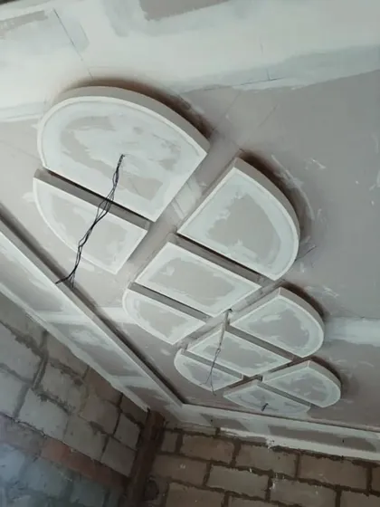 An abstract geometric pattern under construction. This shows how I build up layers of gypsum board to create three-dimensional effects on the ceiling.