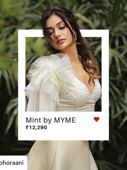 Our "Mint by MYME" set, featuring the organza exaggerated sleeve blouse, is a perfect example of our fusion wear. It's a statement piece designed for any special occasion.