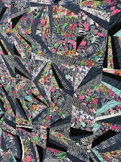 A strip-pieced quilt with a wild, abstract design.