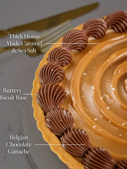 This image breaks down the delicious components of my Chocolate Pudding Tart, showing the buttery biscuit base, the thick house-made caramel, and the Belgian chocolate ganache.