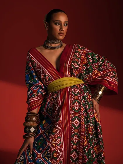 Here, I've styled a traditional Patola-inspired kaftan from Ravissant, blending heritage textiles with a modern silhouette. The rich colors and patterns are balanced with a contemporary waist belt and minimal accessories to create a striking, culturally relevant fashion statement.