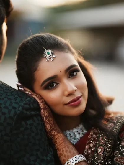 A close-up of Dr. Saruna's reception makeup. The look features a defined smoky eye and a beautiful lip colour that enhances her smile.