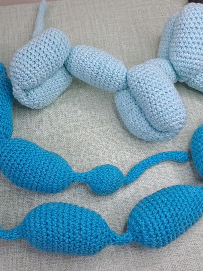 Two of my crochet balloon dogs, one light blue and one dark blue.