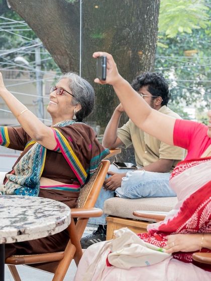 A beautiful moment of connection across generations, as audience members capture memories of the author's reading on their phones.