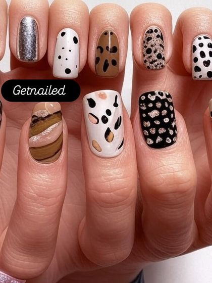 A showcase of various animal-inspired prints on nail tips. This demonstrates the variety of patterns I can create, from dalmatian spots to leopard and cheetah prints.