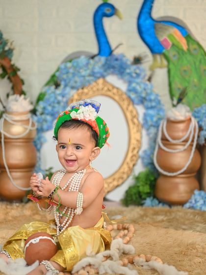 A happy Little Krishna, laughing and playing during his photoshoot.