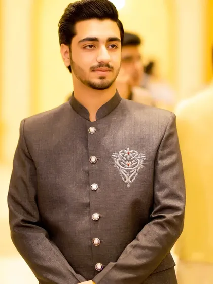 A close-up of the groom's Jodhpuri suit. The intricate embroidery on the chest adds a touch of custom luxury.