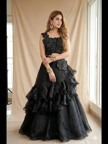A full-length view of the black ruffled lehenga. This is a high-fashion, dramatic choice for a sangeet or cocktail party, perfect for someone who loves to stand out.