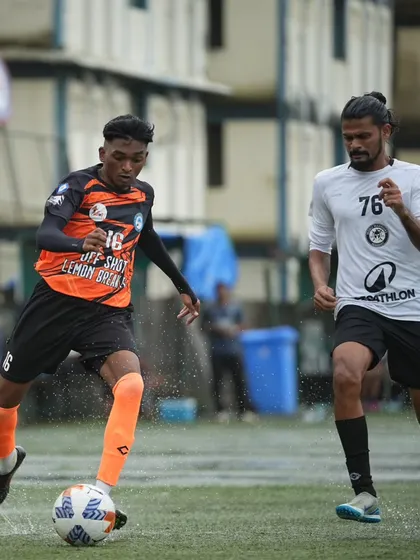 Our winger takes on a defender, showcasing speed and dribbling ability in a wide area of the pitch.