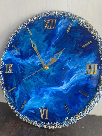 A deep blue, almost celestial-looking resin clock with a full crystal border.