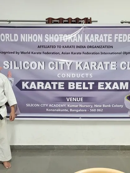 Our Sensei stands before the official banner of the World Nihon Shotokan Karate Federation during a belt exam. We are proud of our affiliation and the high standards it represents.