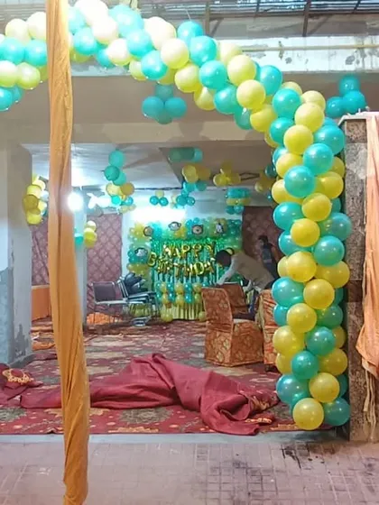 A simple balloon arch entrance for a party in a basement or community hall. This is a great way to welcome guests and set the party mood.