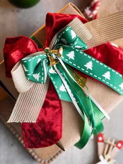 A beautifully wrapped gift is a joy to give and receive. This is an example of the kind of stunning, professional-level gift wrapping you can learn in my workshops, complete with layered bows and festive details.