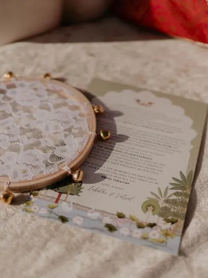 A custom-designed wedding program with a lace-and-ghungroo tambourine, placed on each seat. This detail not only informed guests but also served as a beautiful keepsake.