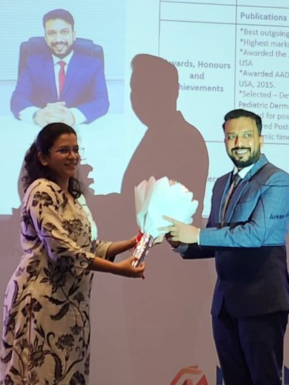 Receiving a token of appreciation after participating in a panel discussion on Urticaria with dermatologists from across the city.