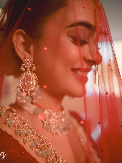 A bridal portrait should capture more than just beauty; it should capture a feeling. This close-up shot, with the soft light catching her smile through the veil, is all about the quiet joy and anticipation a bride feels on her wedding day.