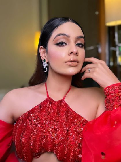 A close-up on the model's glamorous makeup. The styling is designed to be bold and confident, matching the energy of the outfit.