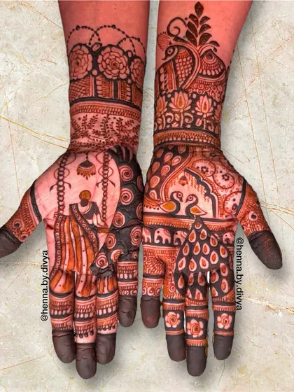 This Teej festival mehendi tells a story with a woman on a swing on one palm, and royal swans and peacocks on the other. The design is rich with traditional symbolism.