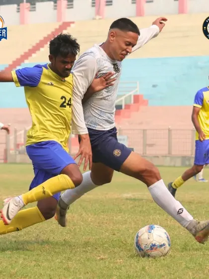 Shielding the ball under pressure. This image shows the strength and composure of our players to maintain possession even in tight situations.