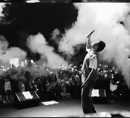 On stage at a campus tour show, surrounded by smoke cannons and an electric crowd. These are the moments that define my live performances.